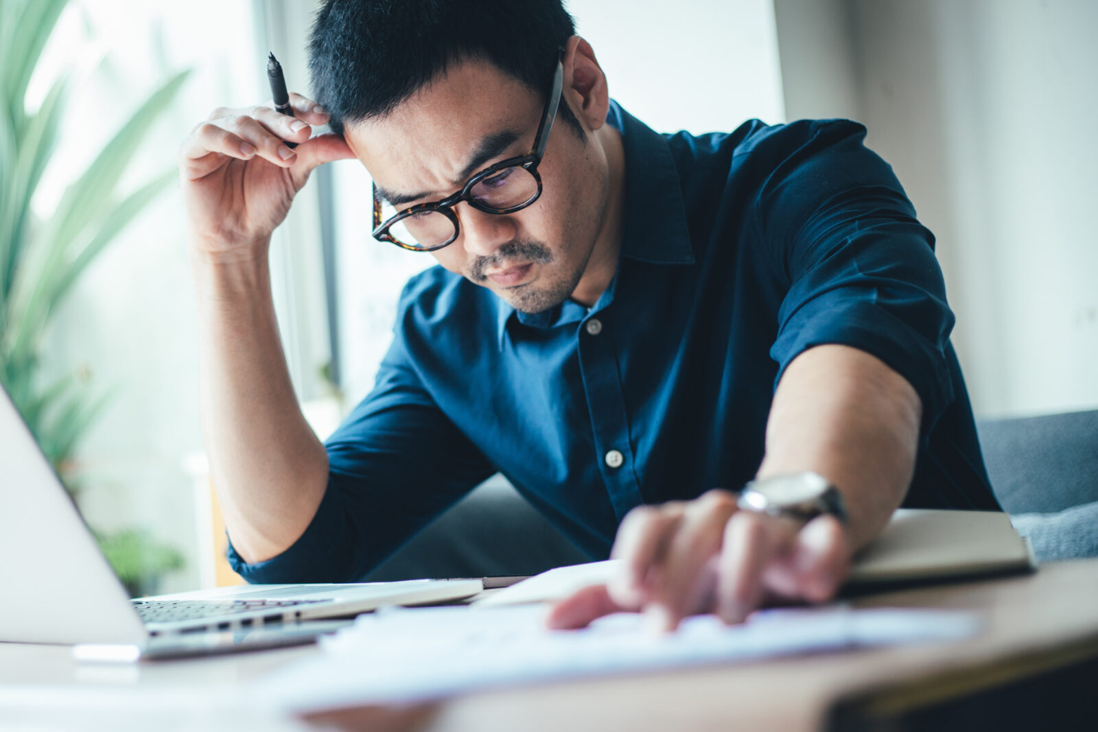 Man serious and reviewing business documents