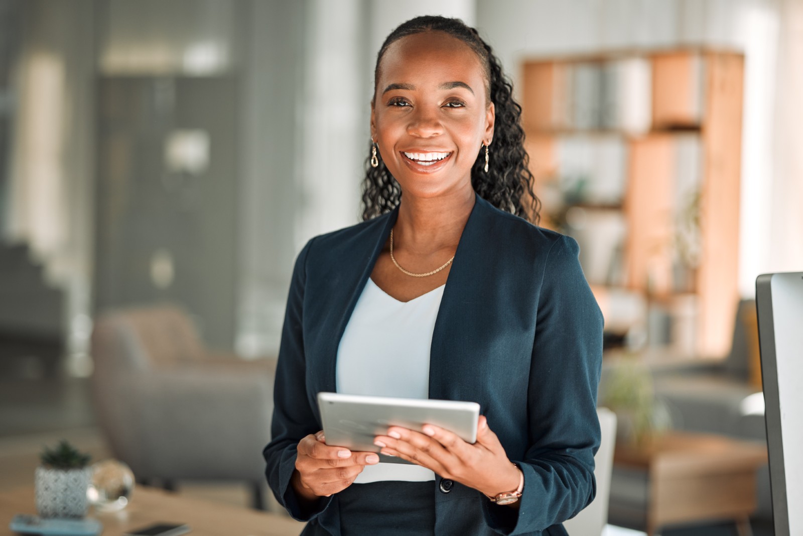 woman standing in office holding a tablet